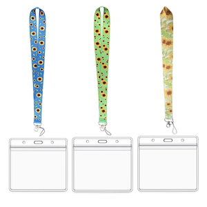 Three sunflower fabric lanyards with transparent ID holders in blue green and cream colors