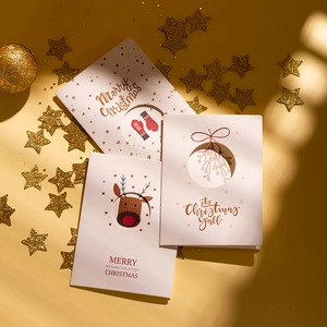 Three-fold Christmas cards with reindeer and mistletoe patterns on festive star background