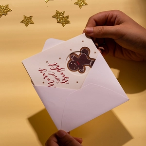 Three-fold Christmas card with Merry and Bright lettering and gingerbread man design