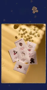 Detailed flat lay of festive Christmas cards with laser-cut patterns and holiday greetings