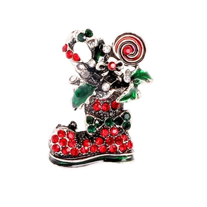 Sparkling Christmas stocking brooch with red and green rhinestones on white background