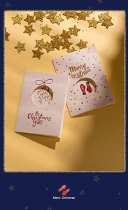 Detail of creative tri-fold Christmas cards with mistletoe and glove patterns on gold stars