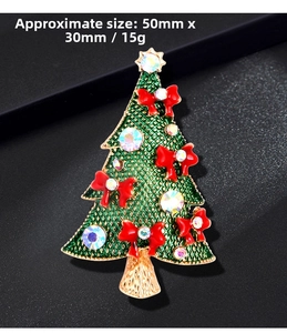 Detail of green enamel Christmas tree brooch with red bow and rhinestones 50mm x 30mm