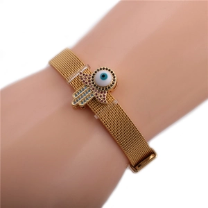 Gold mesh steel bracelet with Hamsa Hand and Evil Eye charms on a model wrist