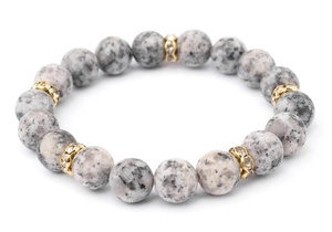 Macro shot of natural spotted stone bead bracelet with gold-plated zircon spacers