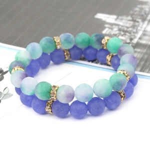 Natural stone bead bracelets set with matte blue and green beads and gold spacers