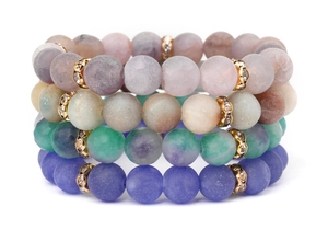 Detail of four matte natural stone bracelets with gold rhinestone spacer beads