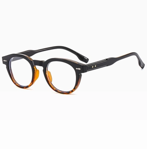 Detailed view of black and tortoise round frames with silver and gold star rivets