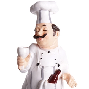 Detail of resin chef figurine holding a wine bottle and glass for home and bar decor