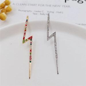 Detail of lightning bolt earrings with colorful and white zircon micro-paving in gold and silver