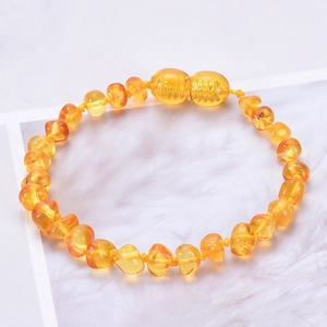 Handmade irregular natural amber beaded bracelet for babies with a secure screw clasp