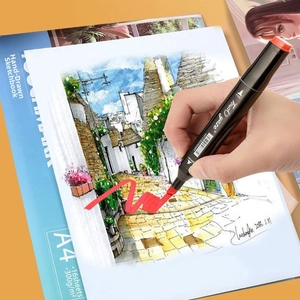 Artist hand using dual-tip marker on A4 300gsm professional drawing paper pad