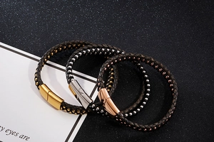 Detail view of woven leather bracelets with magnetic clasps in gold, silver, and rose gold