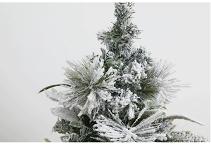 Macro view of snowy PE flocking on green Christmas tree needles with realistic textures