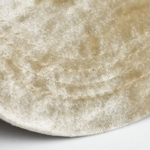 Close-up of golden chenille baseball cap brim with triple parallel stitching detail