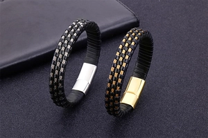 Detailed view of men's braided leather bracelets with gold and silver magnetic clasps