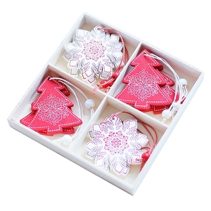 Nordic wooden Christmas ornaments set featuring white snowflakes and red trees in a box