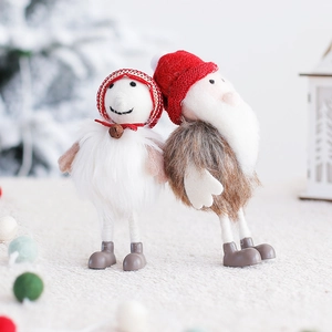 Christmas snowman and Santa Claus wool felt ornaments on a soft white plush background