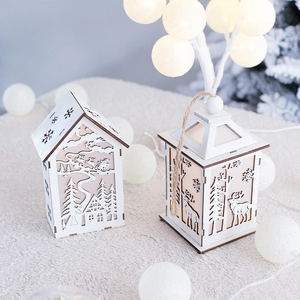 Wooden Christmas LED lantern ornament with cutout forest design on cozy plush background