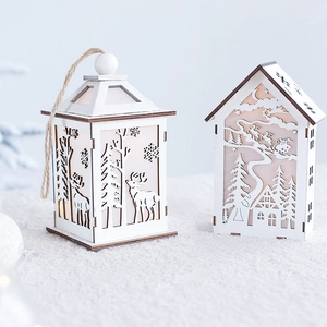 Wooden white Christmas lantern and house LED light boxes on soft plush surface