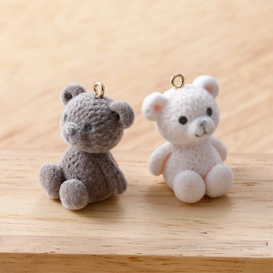 Handmade DIY fuzzy teddy bear charms in grey and white with gold hanging loops