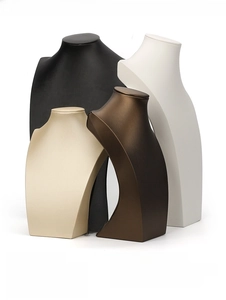 Close-up of PU leather portrait bust necklace display stands in multiple metallic finishes