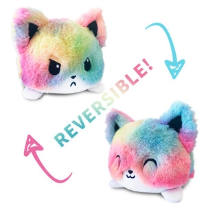 Close-up showing the reversible feature of a rainbow plush toy with two expressions