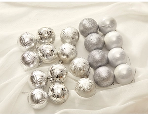 Close-up of silver Christmas ornaments in glitter, matte and engraved textures
