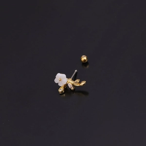Elegant gold flower earring with white petal and diamond leaf on black background