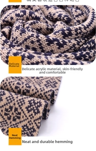 Close-up of winter knit scarf with blue and beige houndstooth pattern made of soft acrylic