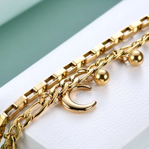 Detail of a 14mm gold-plated double-layer chain bracelet with crescent moon charm and beads