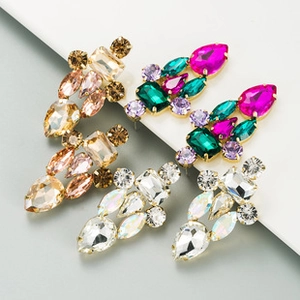 Detail of colorful geometric rhinestone drop earrings in gold setting with crystal gems