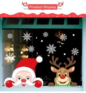 Detail of Christmas window clings featuring Santa Claus, reindeer, and white snowflakes