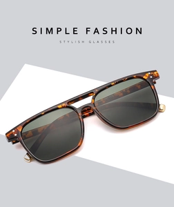 Close-up of tortoise shell sunglasses frame with metallic joints and double bridge detail