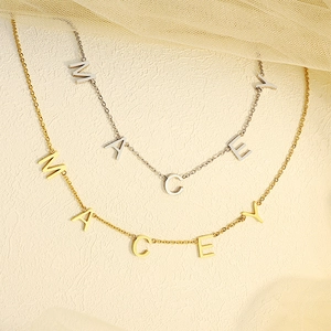 Detail view of custom Macey name necklaces in gold and silver finish with O-shaped chains