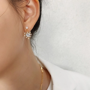 Detail of gold heart stud earrings with zircon crystals and matching paperclip chain necklace