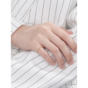 Minimalist gold adjustable open ring with single diamond worn by a professional model