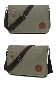 Macro detail of military green canvas messenger bag with leather tag and metal hardware