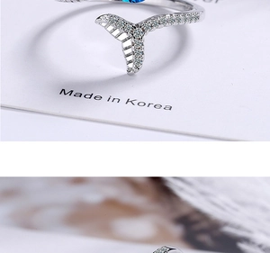Macro shot of silver fishtail ring featuring blue heart diamond and zircon details