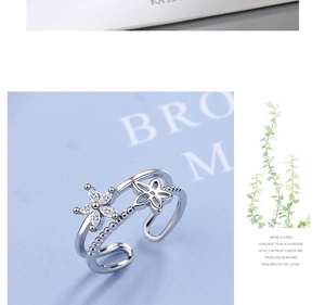Detail of silver floral adjustable ring with sparkling zircon and hollow flower petals