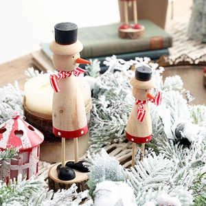 Handcrafted wooden snowman figurine set for Christmas decor with natural log base and accents