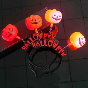 Detail view of Halloween LED pumpkin headband with spring attachments and light-up feature