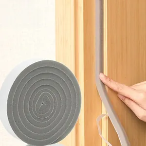 Macro detail of gray foam adhesive sealing strip roll for door and window insulation