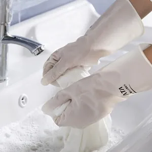 Detailed view of long cuff household cleaning gloves in water with white soapy foam