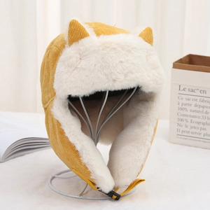 Detail of yellow cat ear hat with thick white faux fur lining for winter warmth