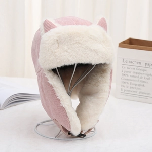 Pink cat ear trapper hat with white faux fur lining and integrated mask for wind protection