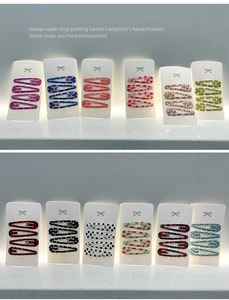 Close-up of 6cm teardrop hair clips with various polka dot and floral print patterns