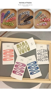 Detailed view of 6cm snap hair clips featuring polka dot, plaid, and leopard prints