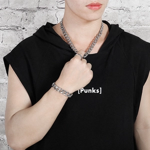 Male model wearing chunky silver cuban chain necklace and matching bracelet set