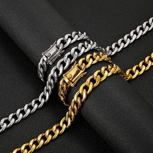 Polished stainless steel Cuban link bracelets in gold and silver on black background